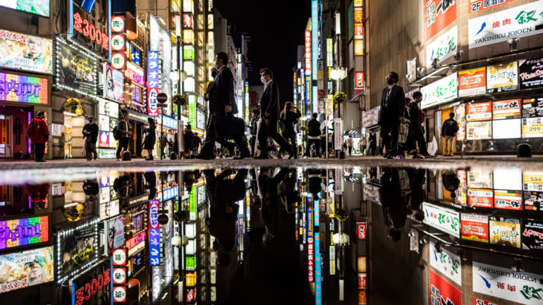 Mọi người đi bộ qua khu giải trí Kabukicho ở Tokyo vào đêm đầu tiên sau khi chính phủ dỡ bỏ tình trạng khẩn cấp về virus coronavirus vào ngày 1 tháng 10. © AP