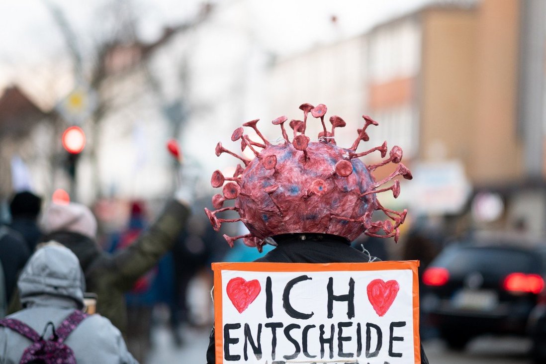 Một người biểu tình đội mũ có hình vi rút thể hiện thái độ chống lại các chính sách dịch bệnh ở Hamburg, Đức vào ngày 22 tháng 1.