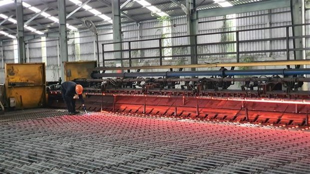 A worker inspects steel billets at a Viet Duc Steel JSC. steel mill in northern Vinh Phuc province. (Photo: VNA)