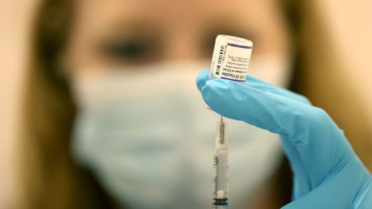 Ashley McGee, a Safeway pharmacist, offers up an injection of Pfizer's booster vaccine at a clinic in San Rafael, California.