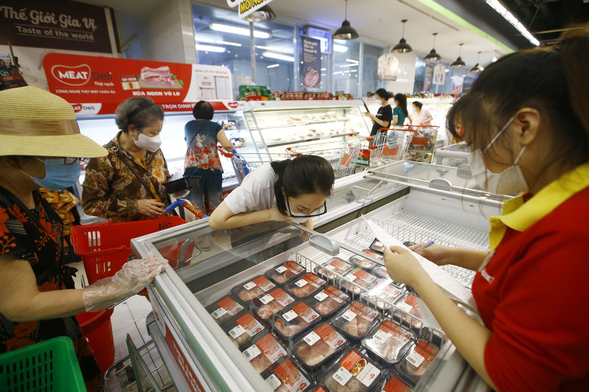 Consumers buy MEATDeli chilled meat at WinMart supermarket.