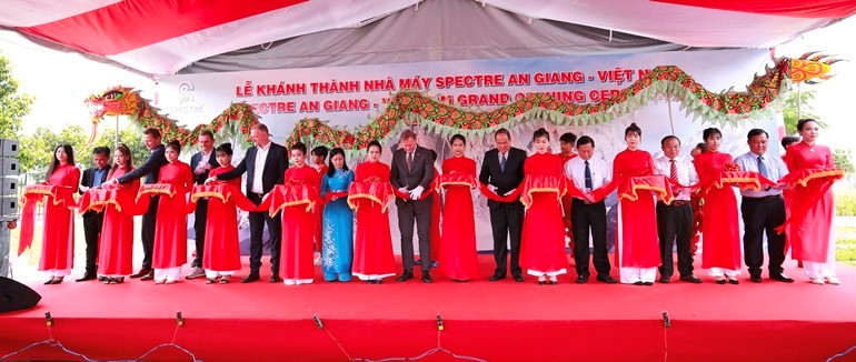 Company executives cut the ribbon to officially open the plant.