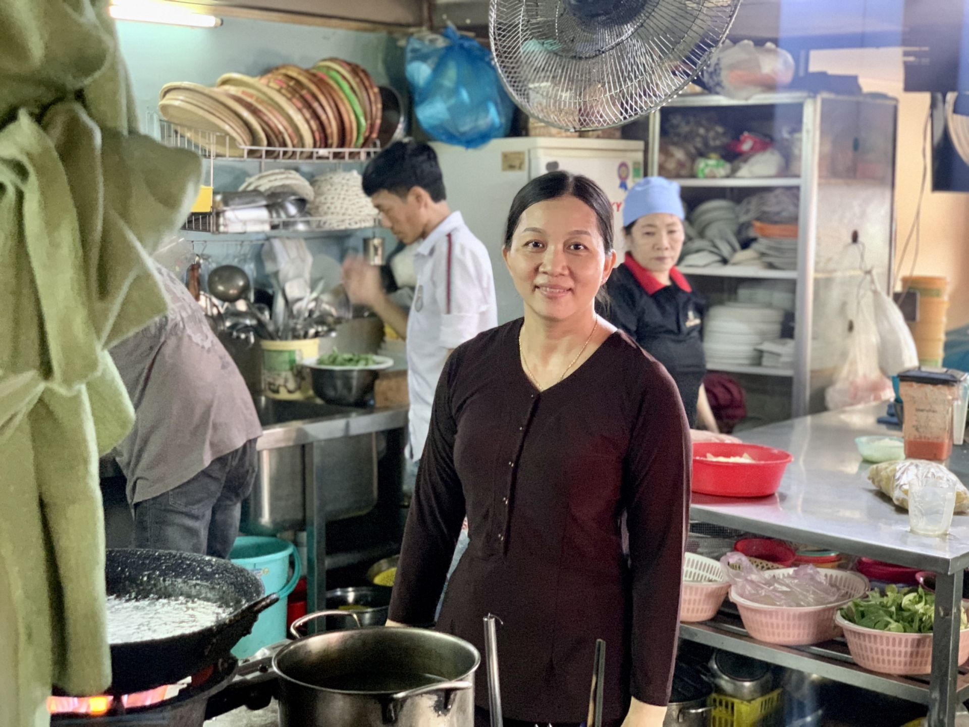 Trần Thị Cẩm Huyền and the staff in the vegan kitchen area of Amitaba Restaurant.