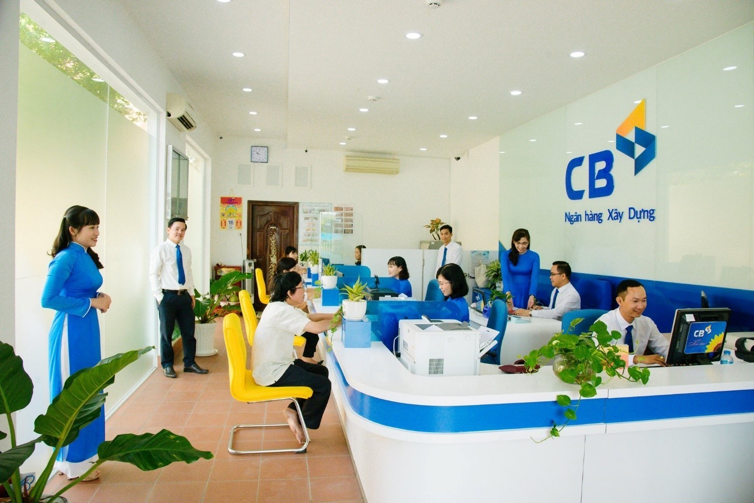 Customers make transactions at CB Bank.