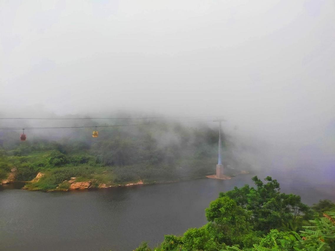 The cable cars are blurry in the clouds