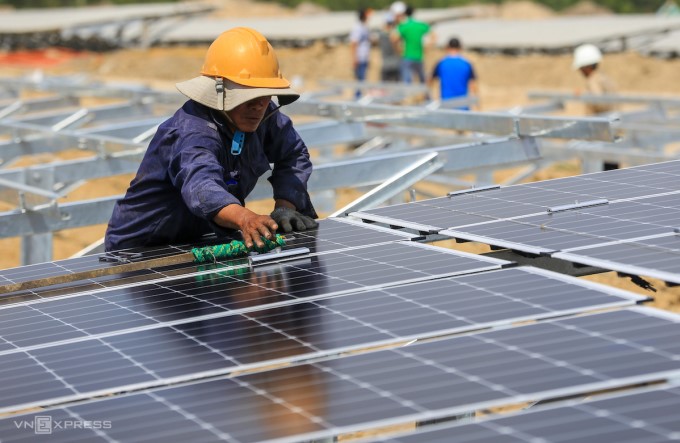 Workers in Ninh Thuan clean solar panels for a project. Photo: Quynh Tran