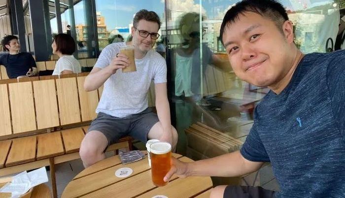 Llion Jones (left) and David Ha (right) meet at a rooftop bar in Tokyo - Photo: CNBC