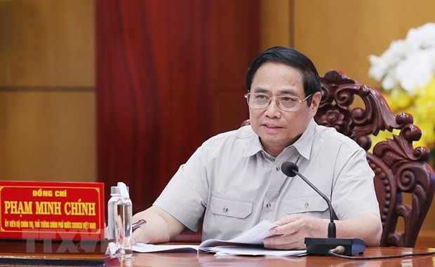 Prime Minister Pham Minh Chinh chaired and worked with key leaders of Long An province. (Photo: Duong Giang/VNA).