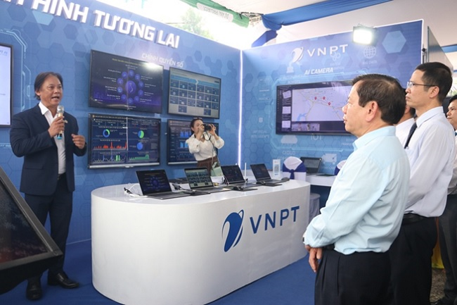 Chủ tịch IBND tỉnh Đặng Văn Minh cùng đại biểu nghe đại diện VNPT trình bày các sản phẩm công nghệ số