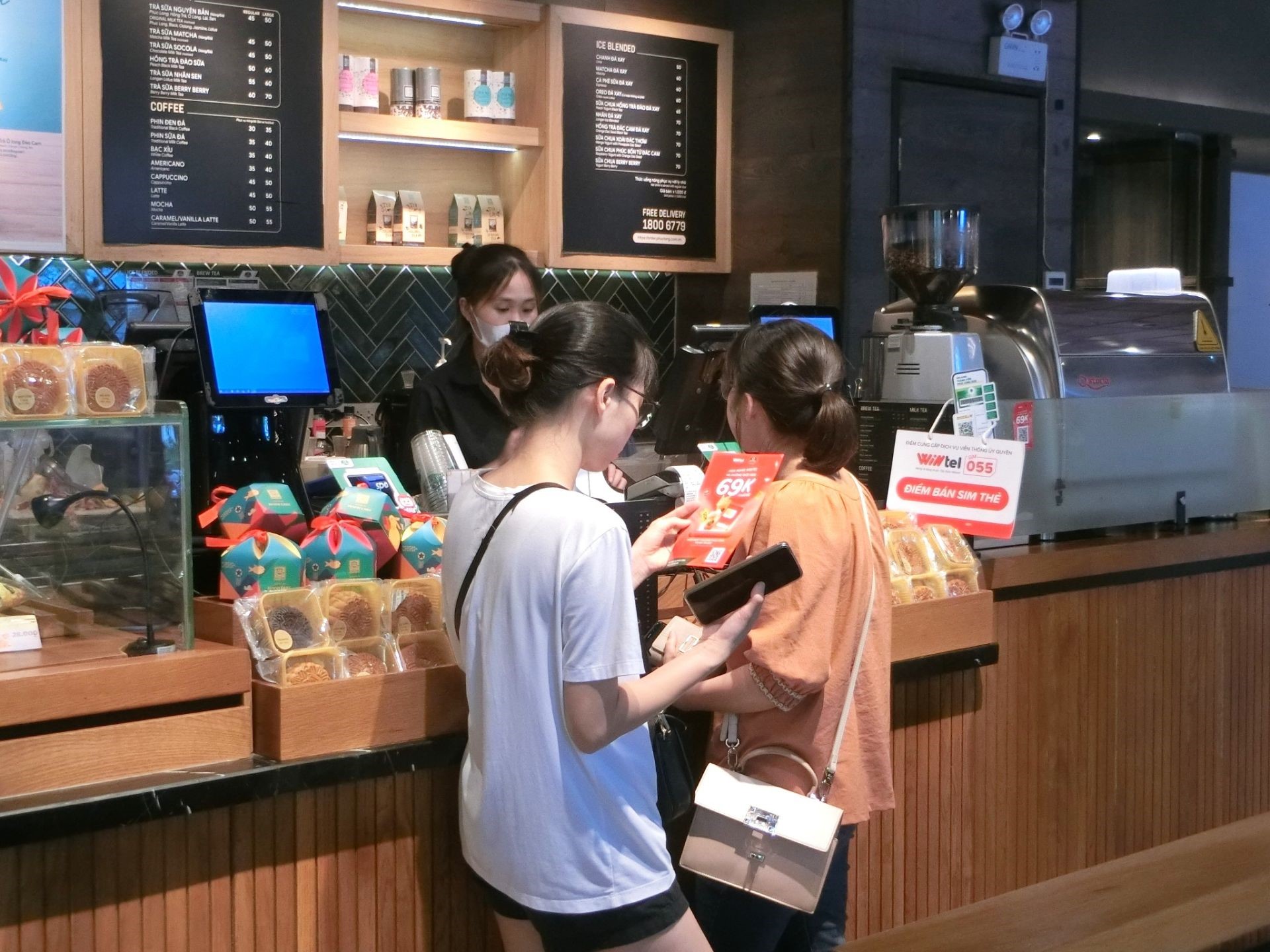 Customers buy Wintel SIM cards at the Phuc Long store - in Hanoi.