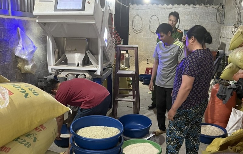 Gia đình ông Khón đang chỉ đạo một số lao động xay xát gạo Séng cù và dùng lá dứa nghiền nhỏ nhuộm xanh gạo