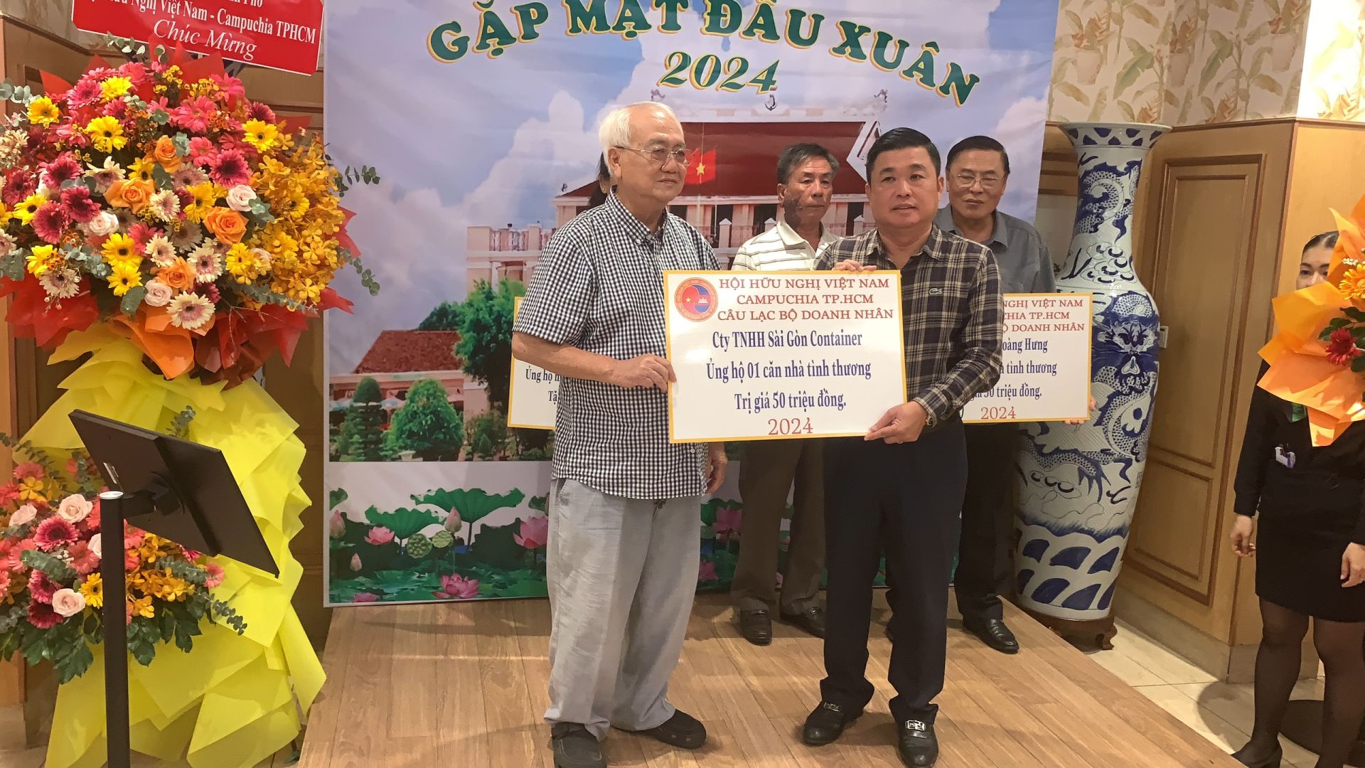 Đại diện công ty TNHH Sài Gòn Container (bìa trái) ủng hộ 1 căn nhà tình thương trị giá 50 triệu đồng
